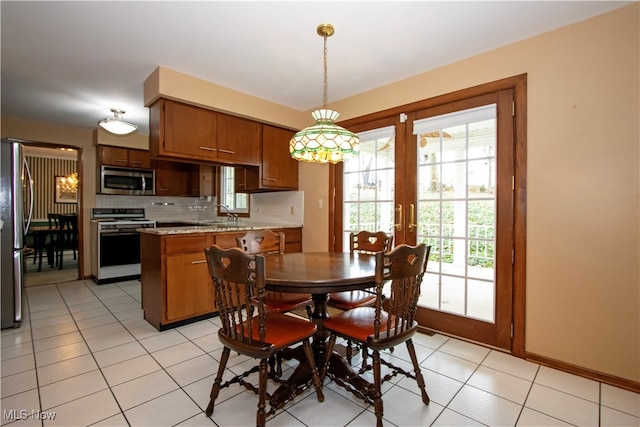 dining space with light tile patterned floors and french doors