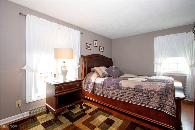 bedroom with dark wood-type flooring