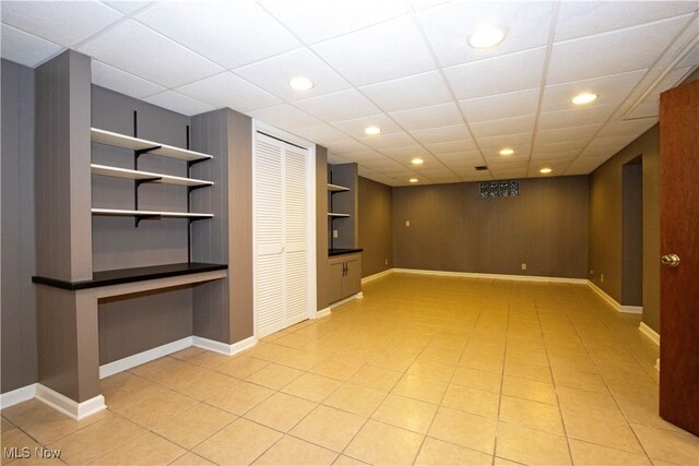 basement featuring a paneled ceiling