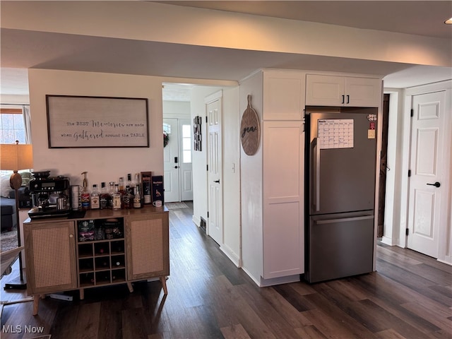 kitchen featuring white cabinets, dark hardwood / wood-style floors, and stainless steel fridge