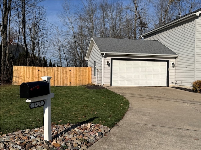 view of side of home with a lawn and a garage