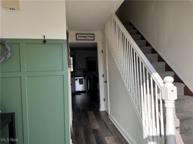 staircase with hardwood / wood-style flooring