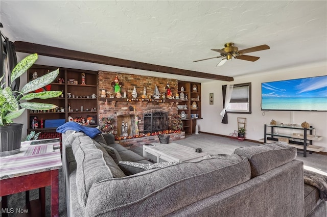 carpeted living room with ceiling fan, built in features, a textured ceiling, and a brick fireplace