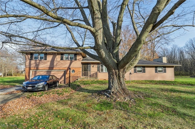 view of front of house with a front yard and a garage