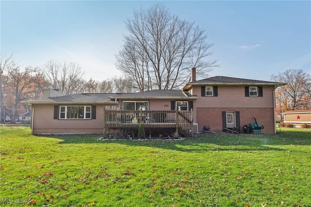 back of house with a deck and a lawn