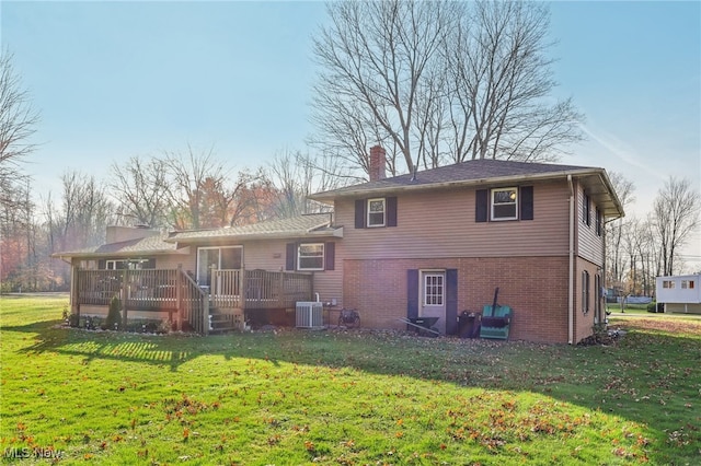 rear view of house with a deck, a yard, and central air condition unit