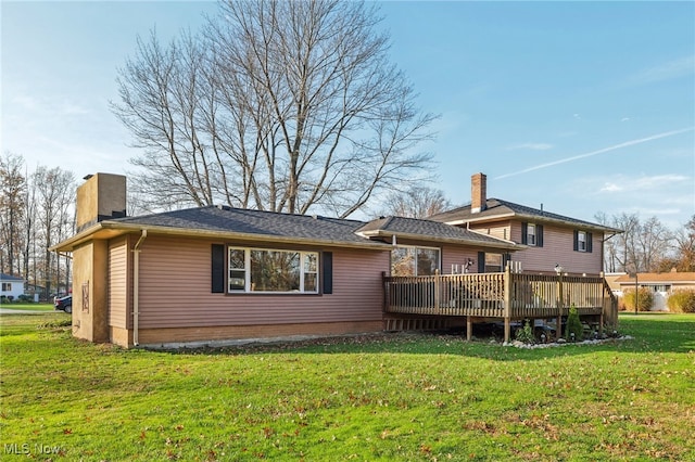 back of house featuring a yard and a deck