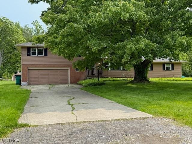 2500 Douglas Rd, Ashtabula, OH 44004 - view of front of property with concrete driveway, an attached garage, and a front yard