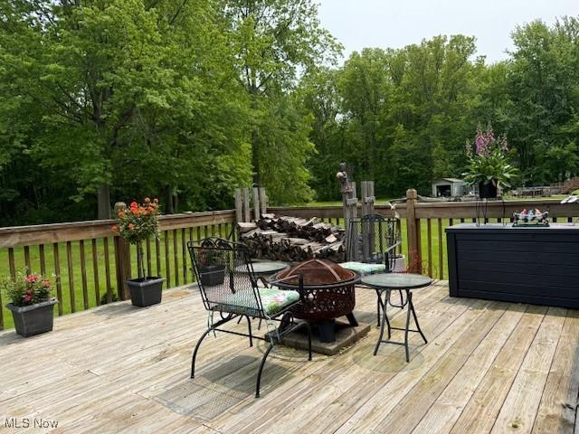 2500 Douglas Rd, Ashtabula, OH 44004 - wooden deck featuring a fire pit
