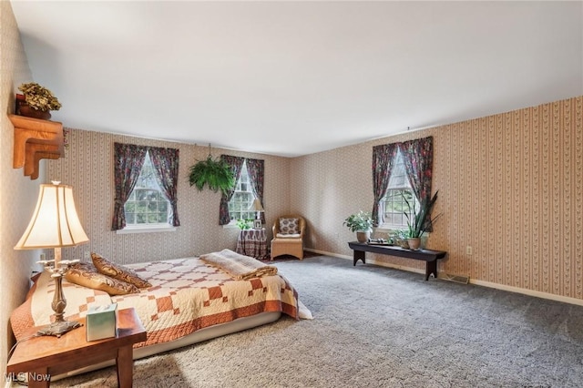 bedroom featuring wallpapered walls, baseboards, and carpet floors