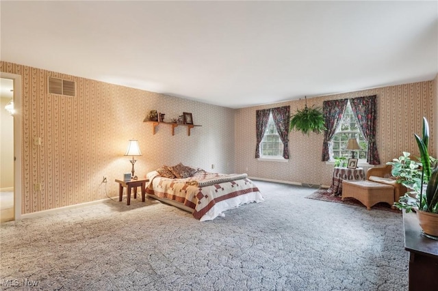 bedroom featuring visible vents, carpet floors, and wallpapered walls