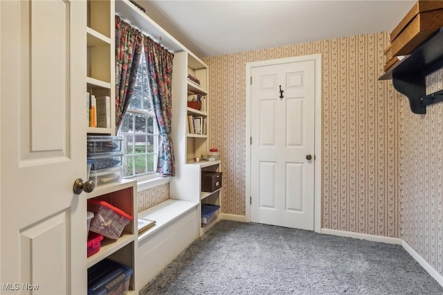 mudroom featuring wallpapered walls, baseboards, and carpet floors