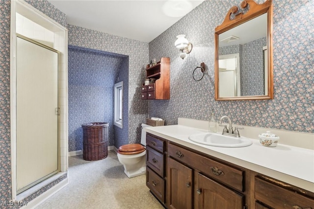 bathroom with toilet, a stall shower, vanity, and wallpapered walls