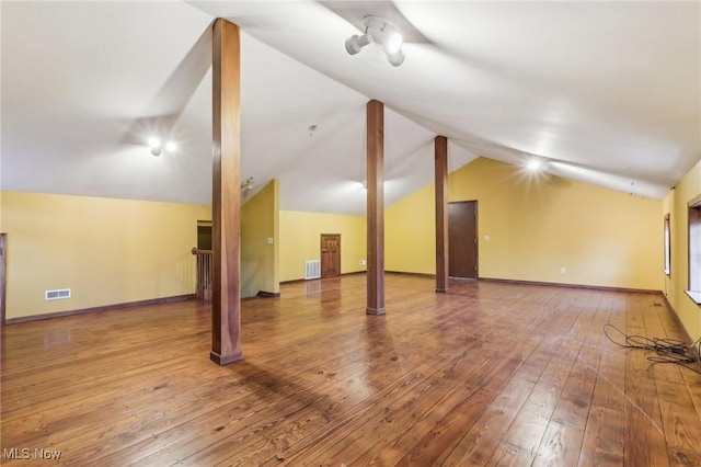 below grade area with hardwood / wood-style floors, visible vents, and baseboards