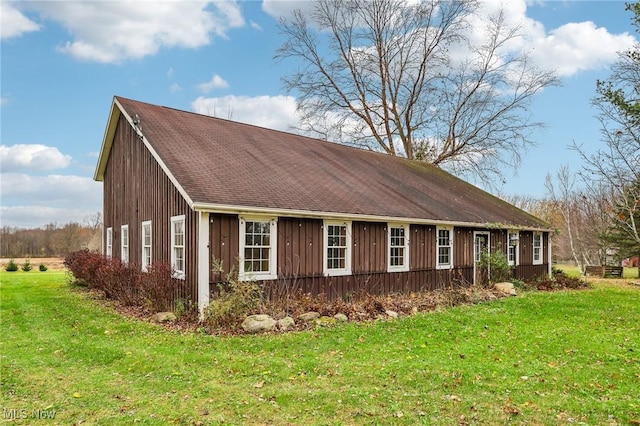 view of home's exterior featuring a lawn and board and batten siding