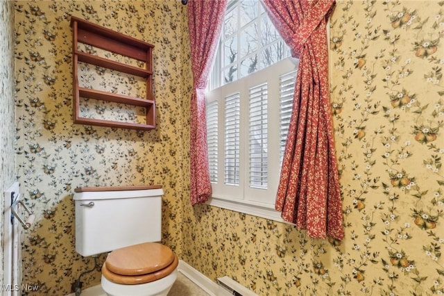 half bathroom featuring wallpapered walls and toilet