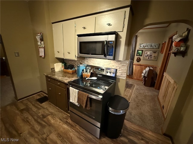 kitchen featuring appliances with stainless steel finishes, dark hardwood / wood-style flooring, tasteful backsplash, and white cabinetry