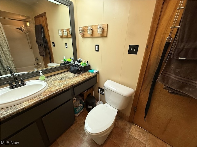 full bathroom featuring toilet, tile patterned floors, vanity, and shower / tub combo with curtain