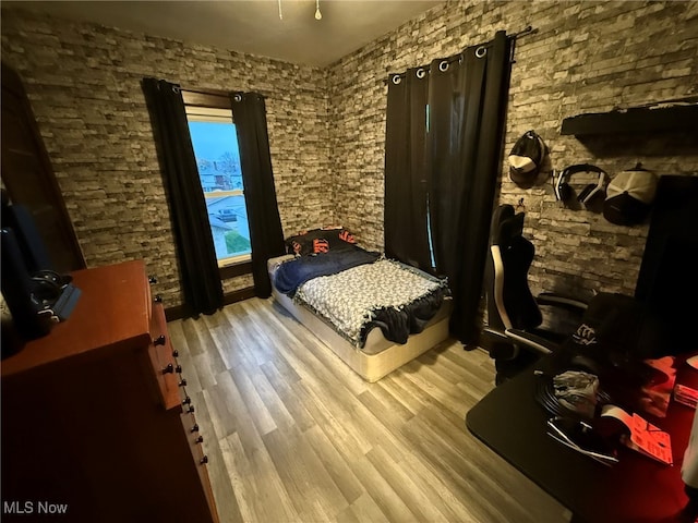 bedroom with hardwood / wood-style flooring