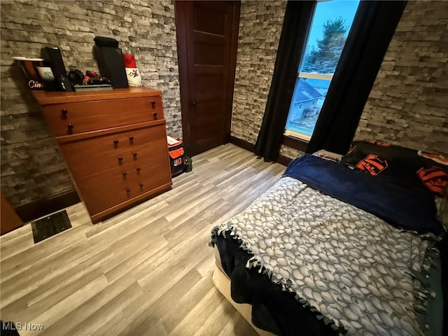 bedroom with light hardwood / wood-style floors