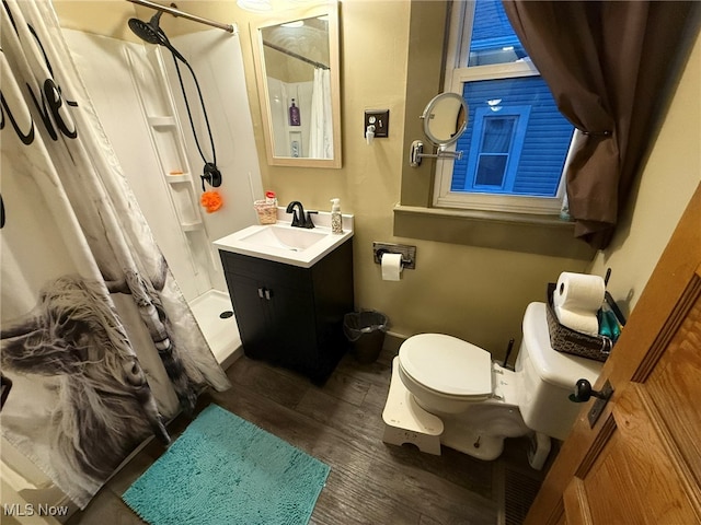 bathroom featuring a shower with curtain, hardwood / wood-style floors, vanity, and toilet