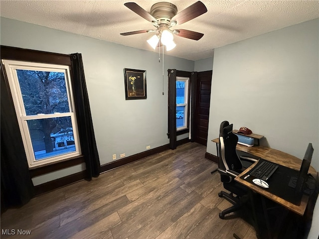 office area with ceiling fan, dark hardwood / wood-style flooring, and a textured ceiling