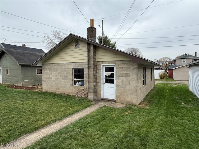 back of house with a lawn