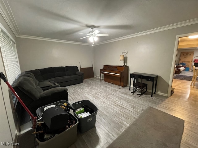 living room featuring hardwood / wood-style flooring, ceiling fan, and ornamental molding