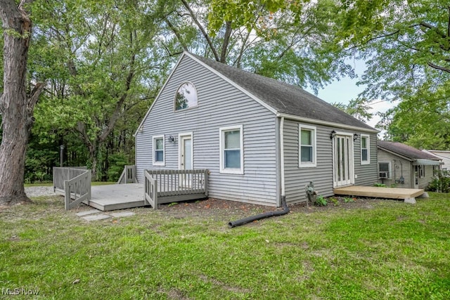 rear view of property with a wooden deck and a yard