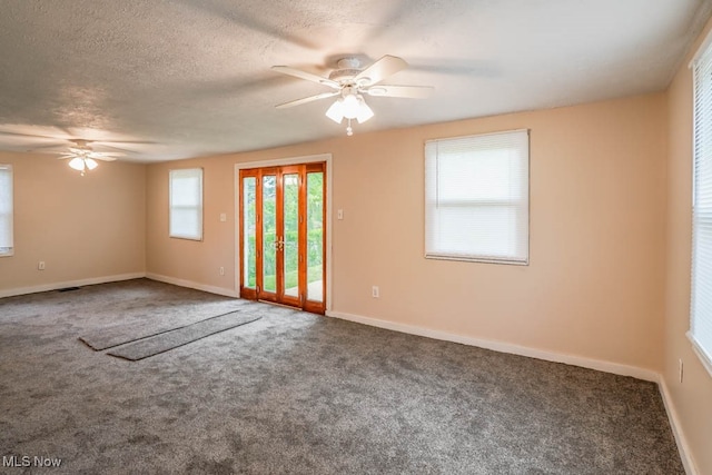 carpeted empty room featuring a textured ceiling and ceiling fan