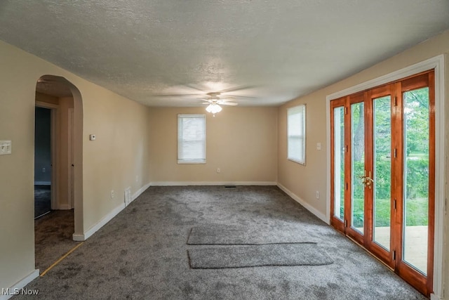 unfurnished room featuring carpet, french doors, a textured ceiling, and ceiling fan