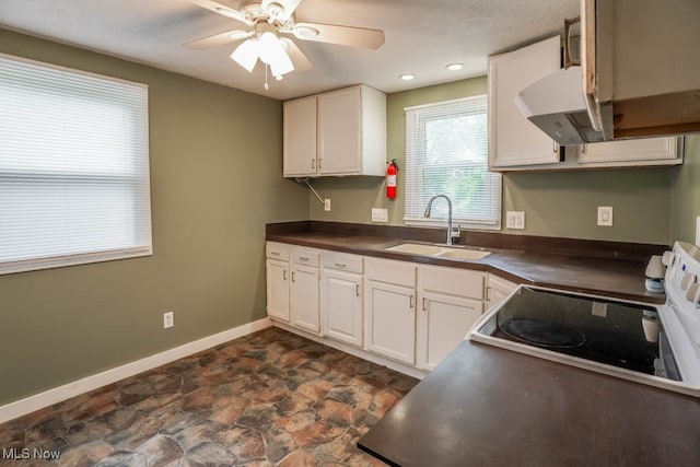 kitchen featuring white cabinets, white range oven, ceiling fan, and sink