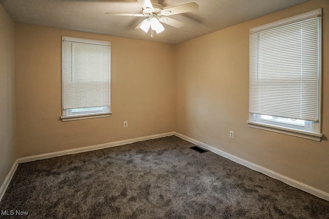 carpeted empty room featuring ceiling fan