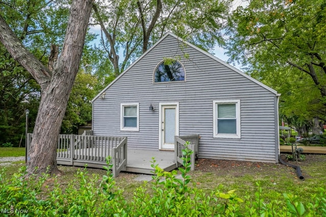 rear view of property featuring a deck