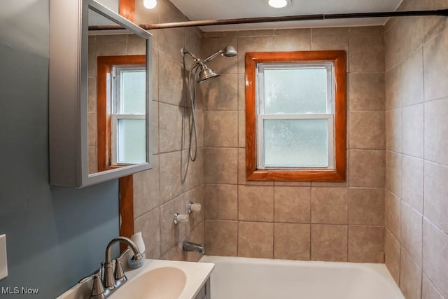 bathroom with vanity and tiled shower / bath