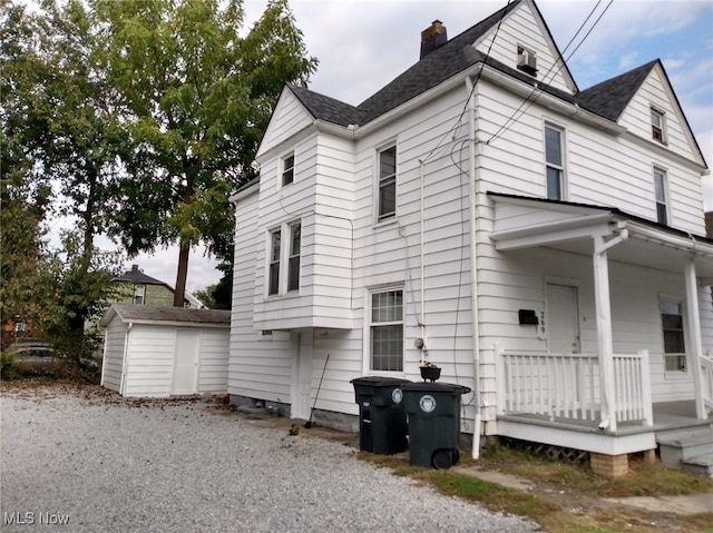 view of side of home with a shed