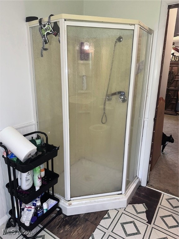 bathroom with a shower with door