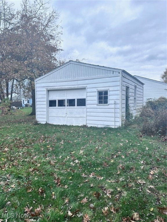 garage featuring a lawn