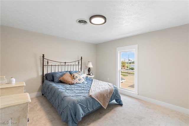 bedroom featuring light carpet