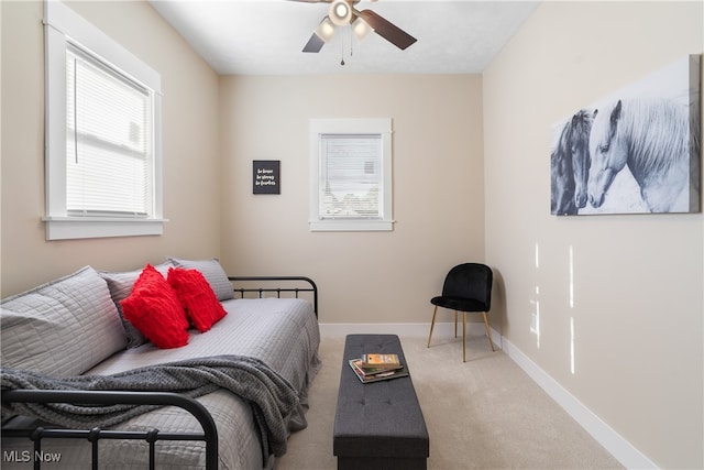 carpeted bedroom featuring ceiling fan and multiple windows