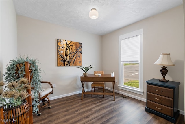 office area with dark hardwood / wood-style flooring and a textured ceiling