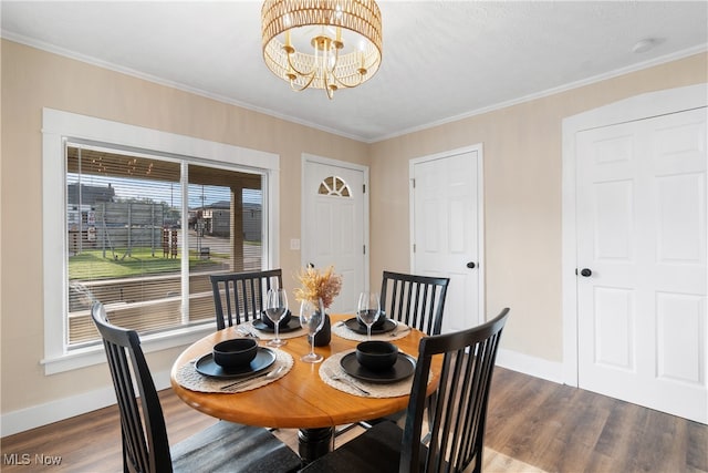 dining area featuring ornamental molding, an inviting chandelier, and dark wood-type flooring