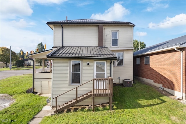 rear view of property featuring a yard