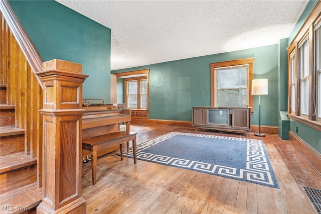 misc room with hardwood / wood-style flooring and a textured ceiling