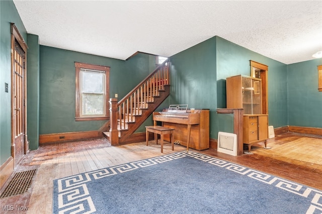 foyer with hardwood / wood-style flooring and a textured ceiling