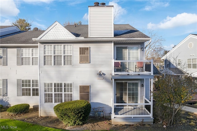 rear view of property with a balcony