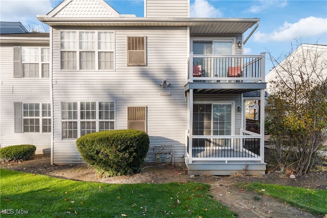 back of property with a balcony