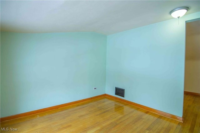 spare room featuring wood-type flooring