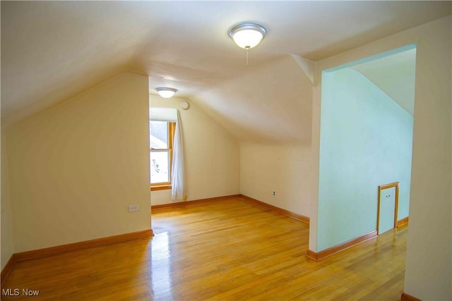 bonus room featuring light hardwood / wood-style flooring and vaulted ceiling