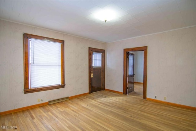 entrance foyer with ornamental molding and light hardwood / wood-style floors